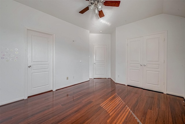 unfurnished bedroom featuring wood finished floors, baseboards, a closet, and ceiling fan