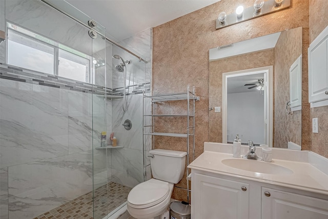 full bath featuring vanity, toilet, ceiling fan, and a shower stall