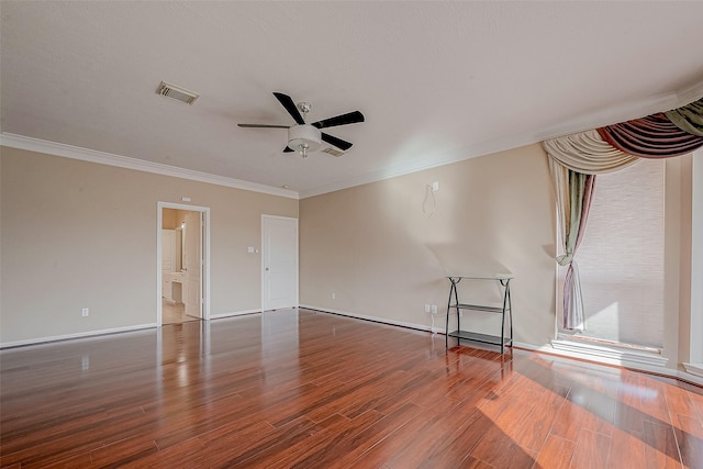 unfurnished room with visible vents, crown molding, a ceiling fan, and wood finished floors