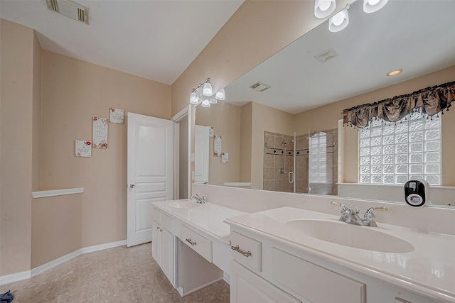 bathroom with visible vents, a shower stall, and a sink