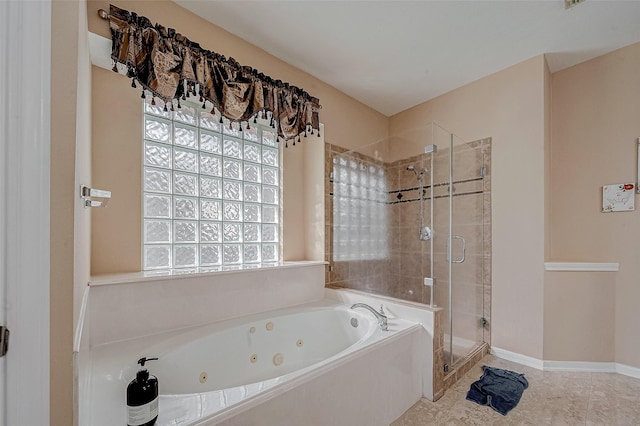 bathroom with a shower stall, a jetted tub, plenty of natural light, and baseboards