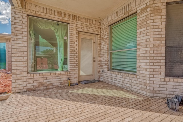 doorway to property with brick siding