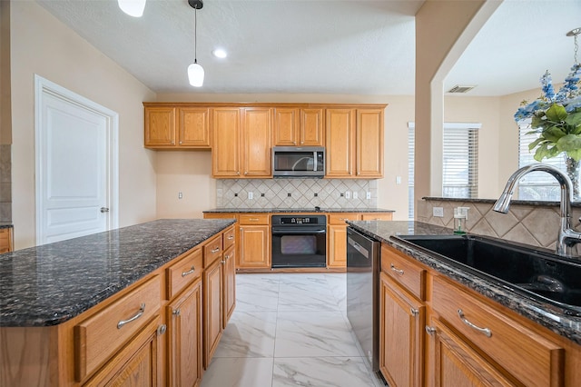 kitchen with visible vents, a sink, appliances with stainless steel finishes, decorative light fixtures, and marble finish floor