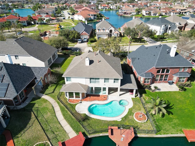 drone / aerial view with a residential view and a water view