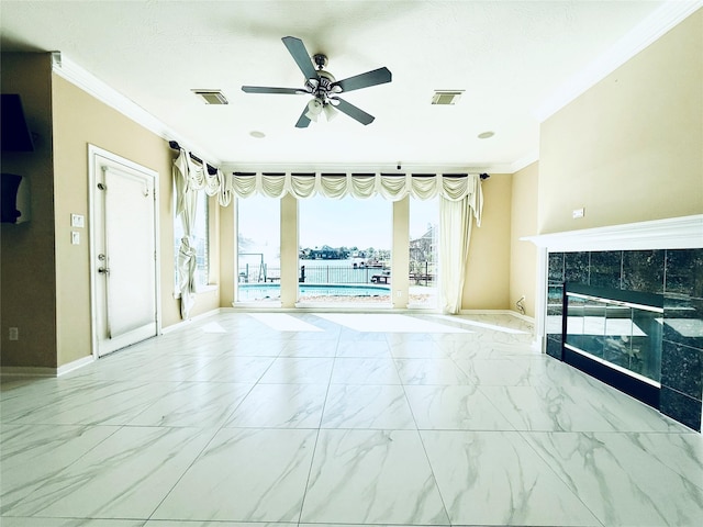 unfurnished living room featuring a ceiling fan, visible vents, a fireplace, crown molding, and marble finish floor