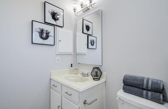 half bath with vanity and toilet