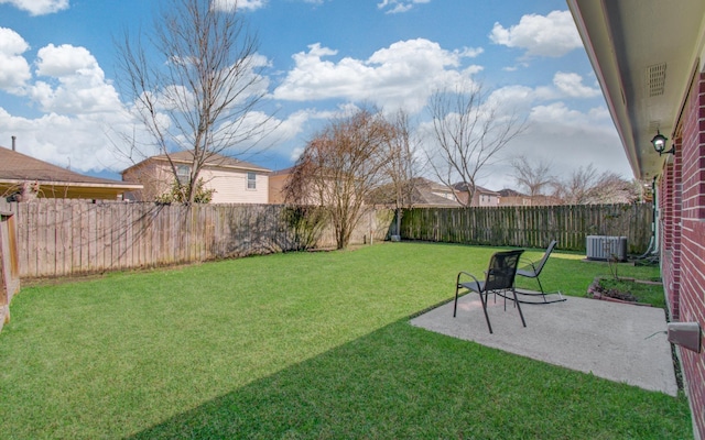 view of yard featuring a patio, a fenced backyard, and central air condition unit