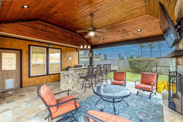 view of patio / terrace with outdoor dry bar, a ceiling fan, and fence