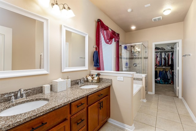 full bath featuring tile patterned flooring, a shower stall, visible vents, and a sink