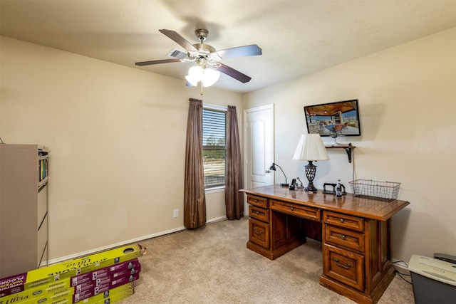 home office featuring baseboards, light carpet, visible vents, and ceiling fan