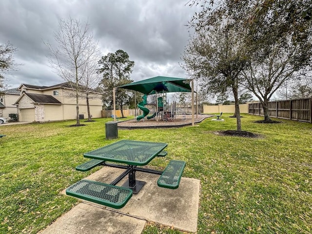 surrounding community featuring a yard, fence, and playground community