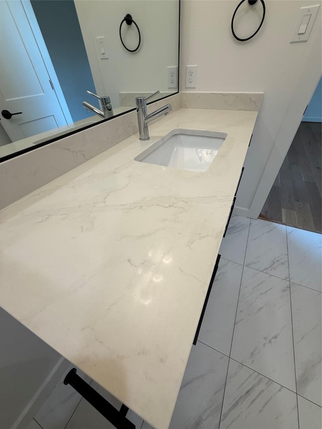 bathroom featuring marble finish floor and vanity