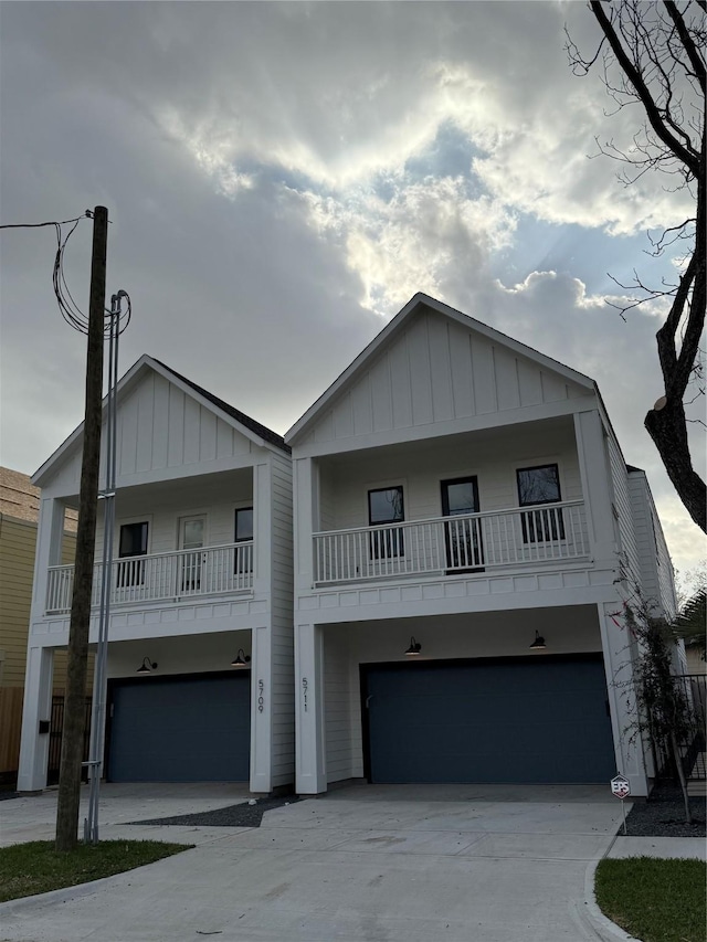 view of front of property featuring board and batten siding, driveway, and an attached garage