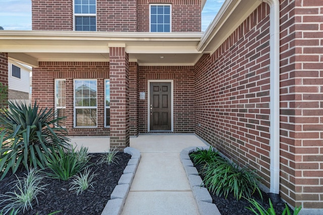 property entrance featuring brick siding