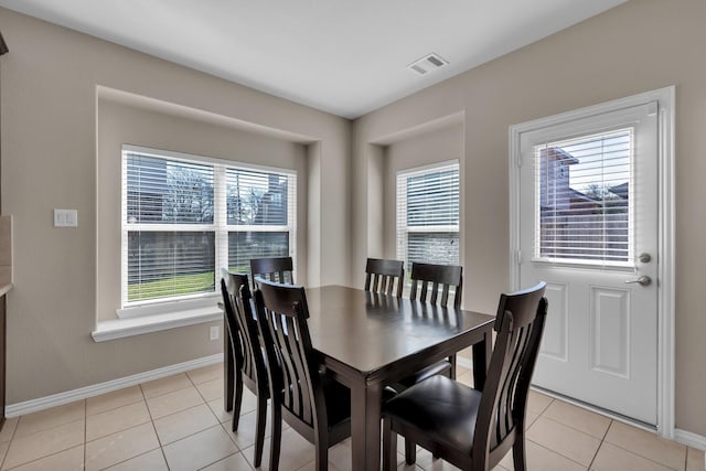 dining space featuring visible vents, baseboards, and light tile patterned floors