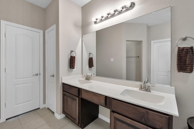 bathroom featuring double vanity, a sink, and tile patterned floors