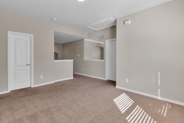 unfurnished room with carpet and baseboards