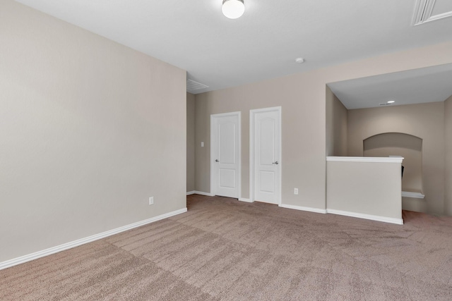 carpeted empty room with baseboards