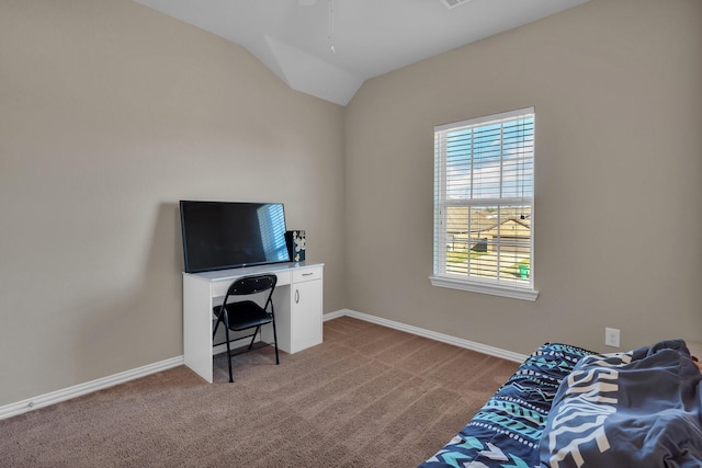 office space featuring carpet, baseboards, and vaulted ceiling