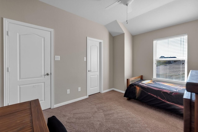 bedroom featuring a ceiling fan, carpet flooring, vaulted ceiling, and baseboards