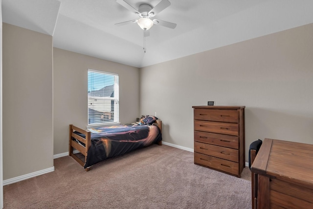 bedroom with vaulted ceiling, carpet floors, a ceiling fan, and baseboards