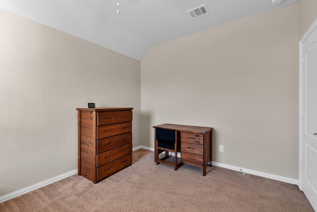 office area with lofted ceiling, carpet flooring, visible vents, and baseboards