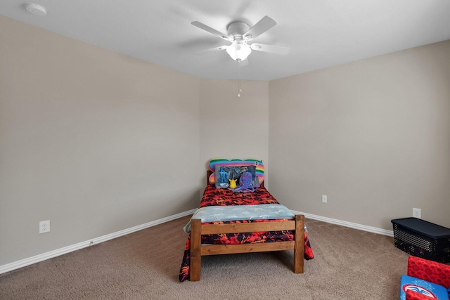 carpeted bedroom with ceiling fan and baseboards