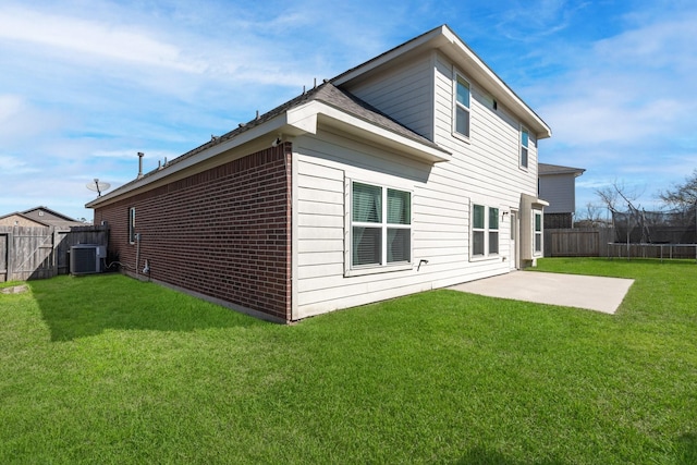 back of property with a fenced backyard, cooling unit, a lawn, a trampoline, and a patio area