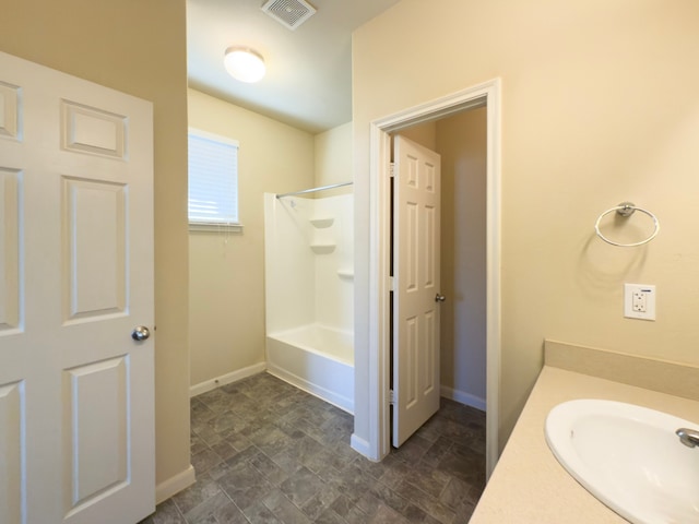 full bath with bathing tub / shower combination, vanity, visible vents, and baseboards