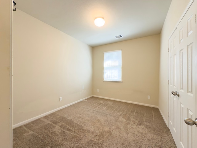 unfurnished bedroom with baseboards, visible vents, and carpet flooring