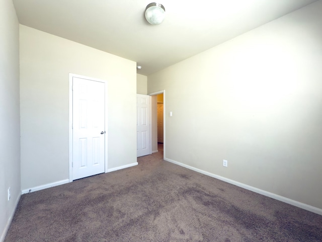 unfurnished bedroom with carpet floors and baseboards