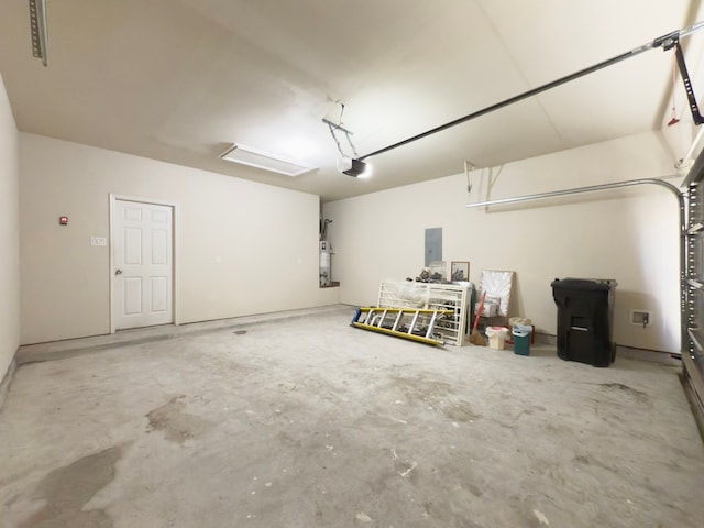 garage featuring secured water heater, electric panel, and a garage door opener