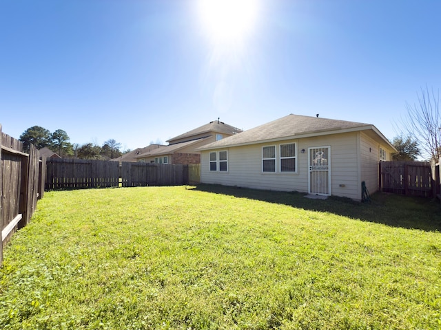 exterior space with a fenced backyard and a yard