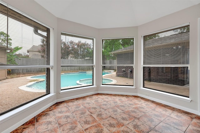 unfurnished sunroom featuring lofted ceiling