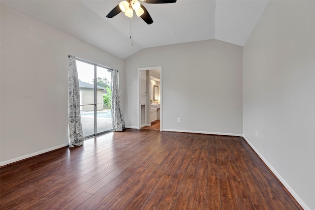 empty room with ceiling fan, vaulted ceiling, baseboards, and wood finished floors