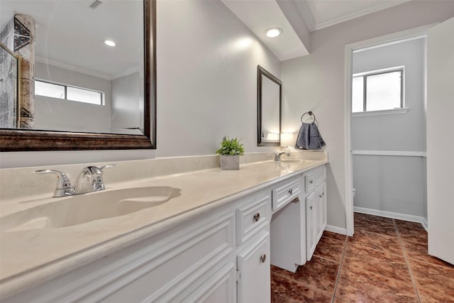 full bath with ornamental molding, a sink, and a wealth of natural light