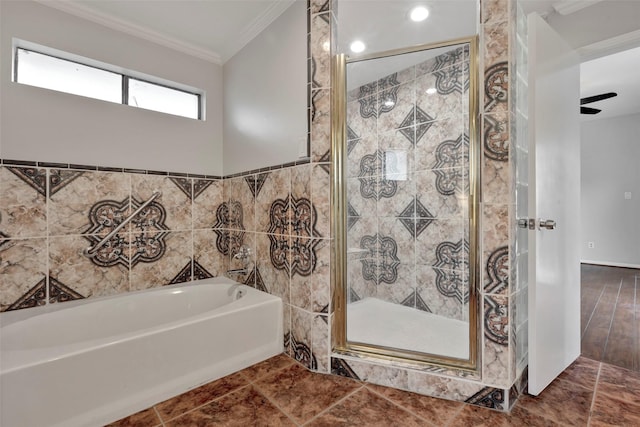 bathroom with a stall shower, ornamental molding, a garden tub, and tile walls