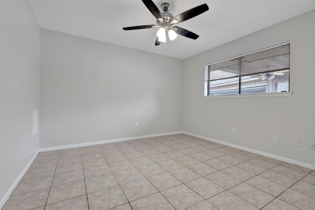 empty room with ceiling fan and baseboards