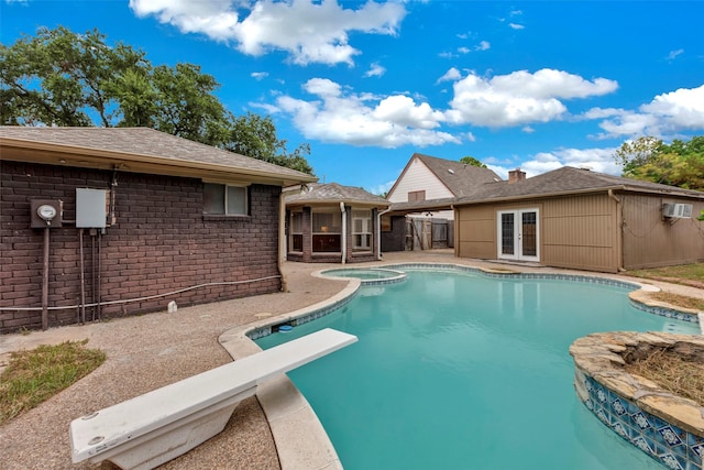 outdoor pool featuring french doors, a patio area, fence, and a diving board