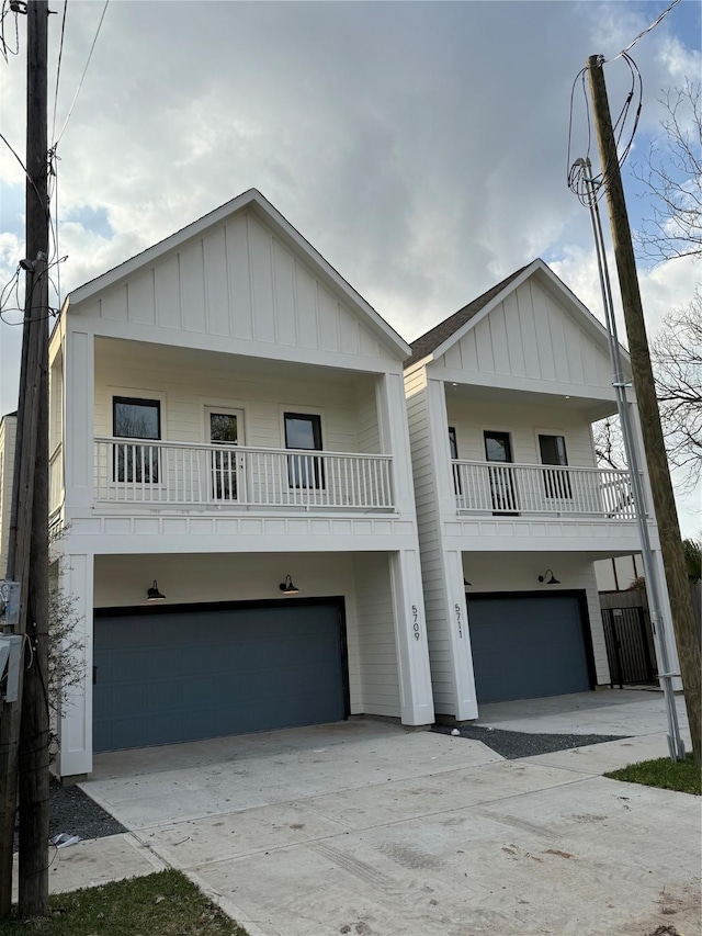 view of front of property with board and batten siding, concrete driveway, and an attached garage