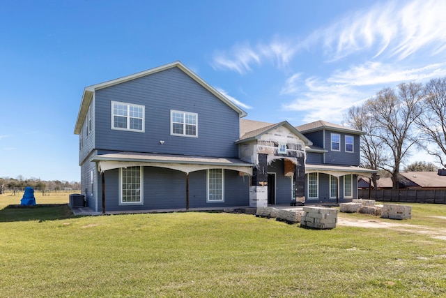 view of front of house featuring a front lawn, fence, and central air condition unit