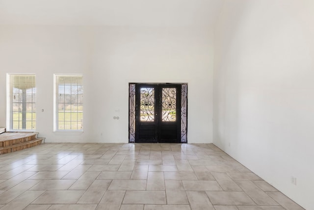 2464 N Walker Rd, Cleveland, TX 77328 - foyer with french doors and light tile patterned floors