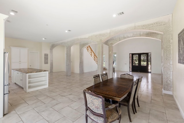 dining room with visible vents, arched walkways, baseboards, french doors, and recessed lighting