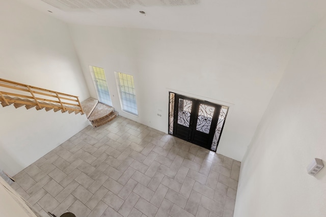 foyer with french doors and a high ceiling