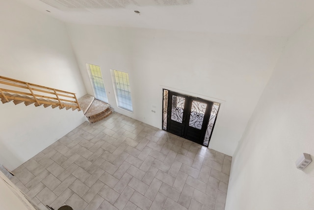 2464 N Walker Rd, Cleveland, TX 77328 - entryway with french doors, high vaulted ceiling, and stairway