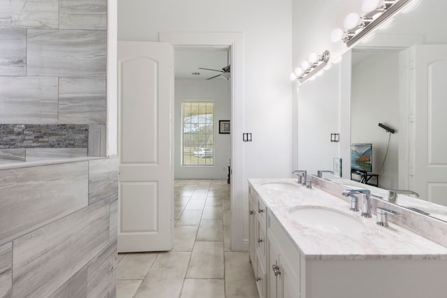 full bath featuring ceiling fan, tile patterned floors, a sink, and double vanity