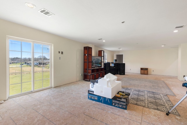 living area featuring a wealth of natural light, visible vents, and recessed lighting