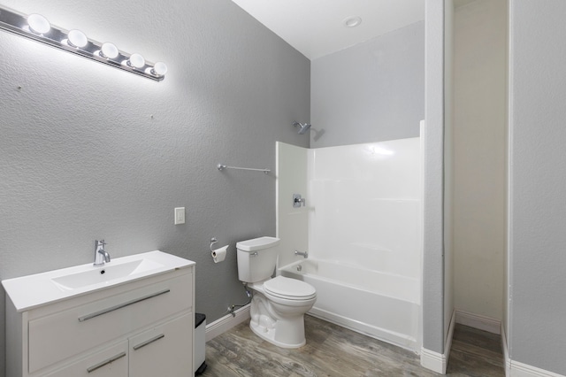 2464 N Walker Rd, Cleveland, TX 77328 - bathroom with wood finished floors, toilet, vanity, shower / bath combination, and baseboards