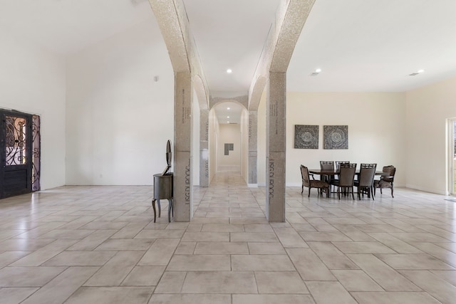 2464 N Walker Rd, Cleveland, TX 77328 - entrance foyer featuring arched walkways, recessed lighting, and a towering ceiling