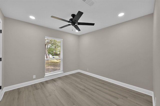 unfurnished room featuring recessed lighting, visible vents, baseboards, and wood finished floors